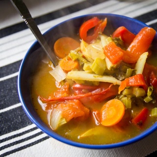 hot and sour soup with kale stems, bell peppers, carrots, potatoes, and tomatoes